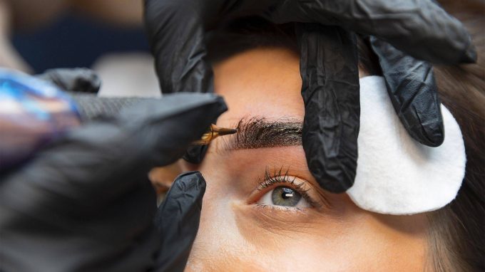young-woman-getting-beauty-treatment-her-eyebrows-v2